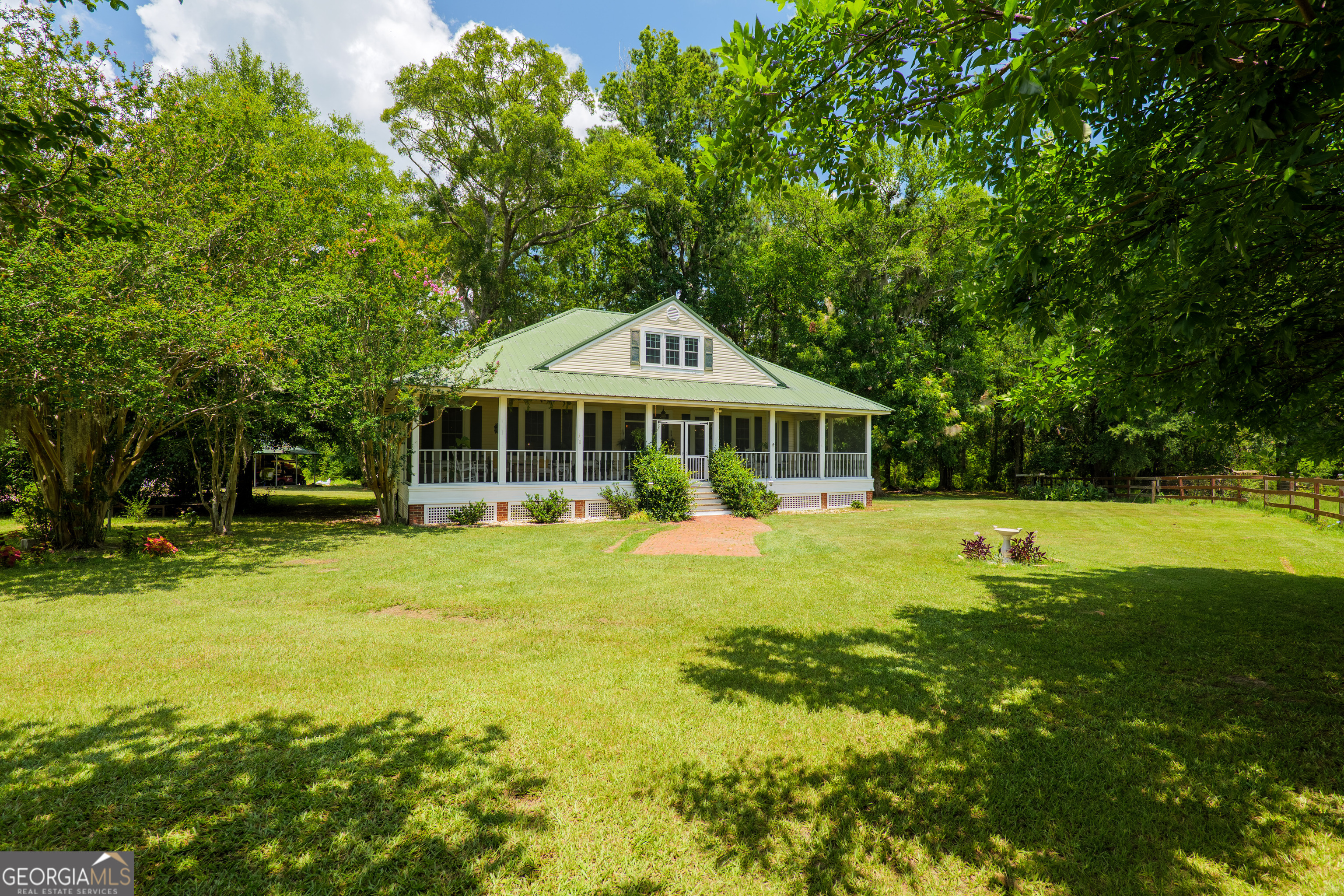 7552 Webb Road Hahira, GA 31632 - Photo 2 of 57 a front view of a house with a yard table and chairs