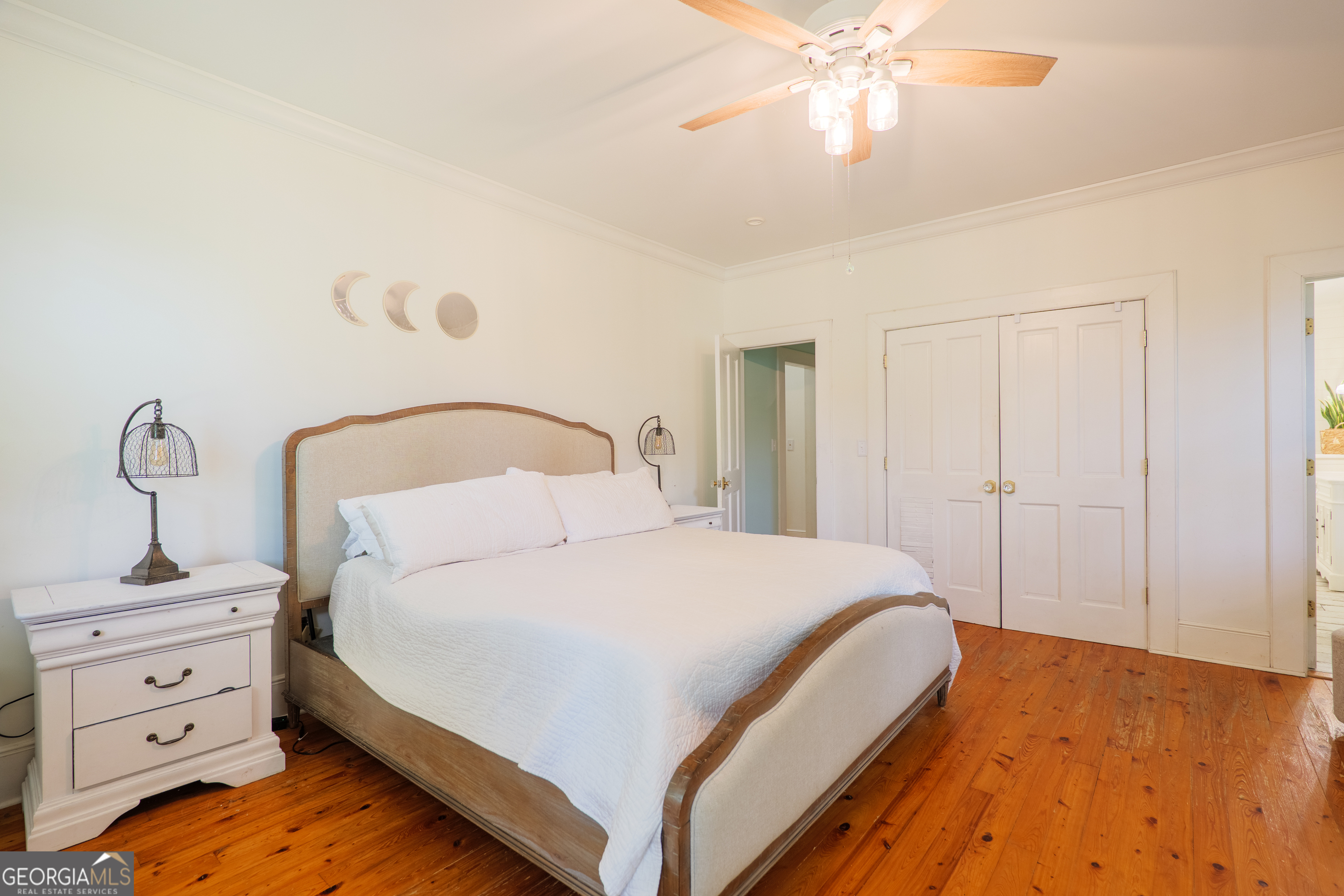 7552 Webb Road Hahira, GA 31632 - Photo 22 of 57 a bedroom with a bed and a chandelier