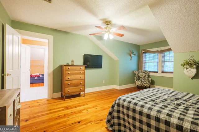 a bedroom with a bed and a table