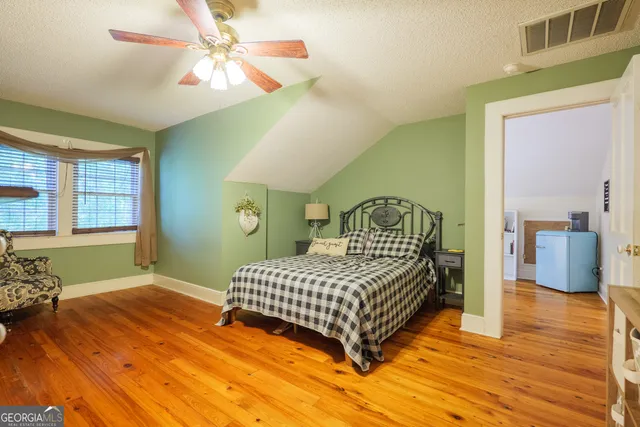 a bedroom with a bed and a large window