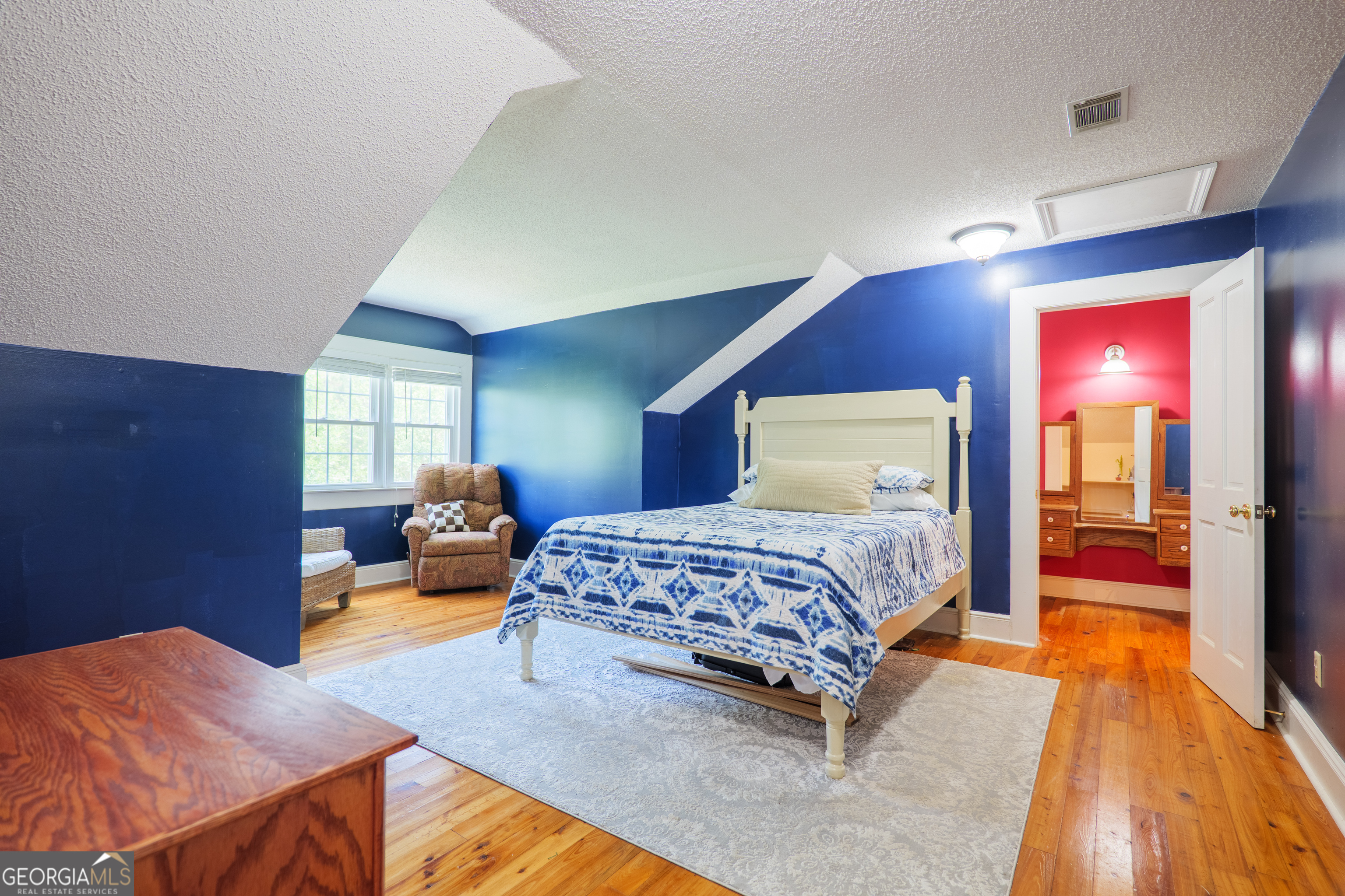 7552 Webb Road Hahira, GA 31632 - Photo 37 of 57 a bedroom with a bed and wooden floor