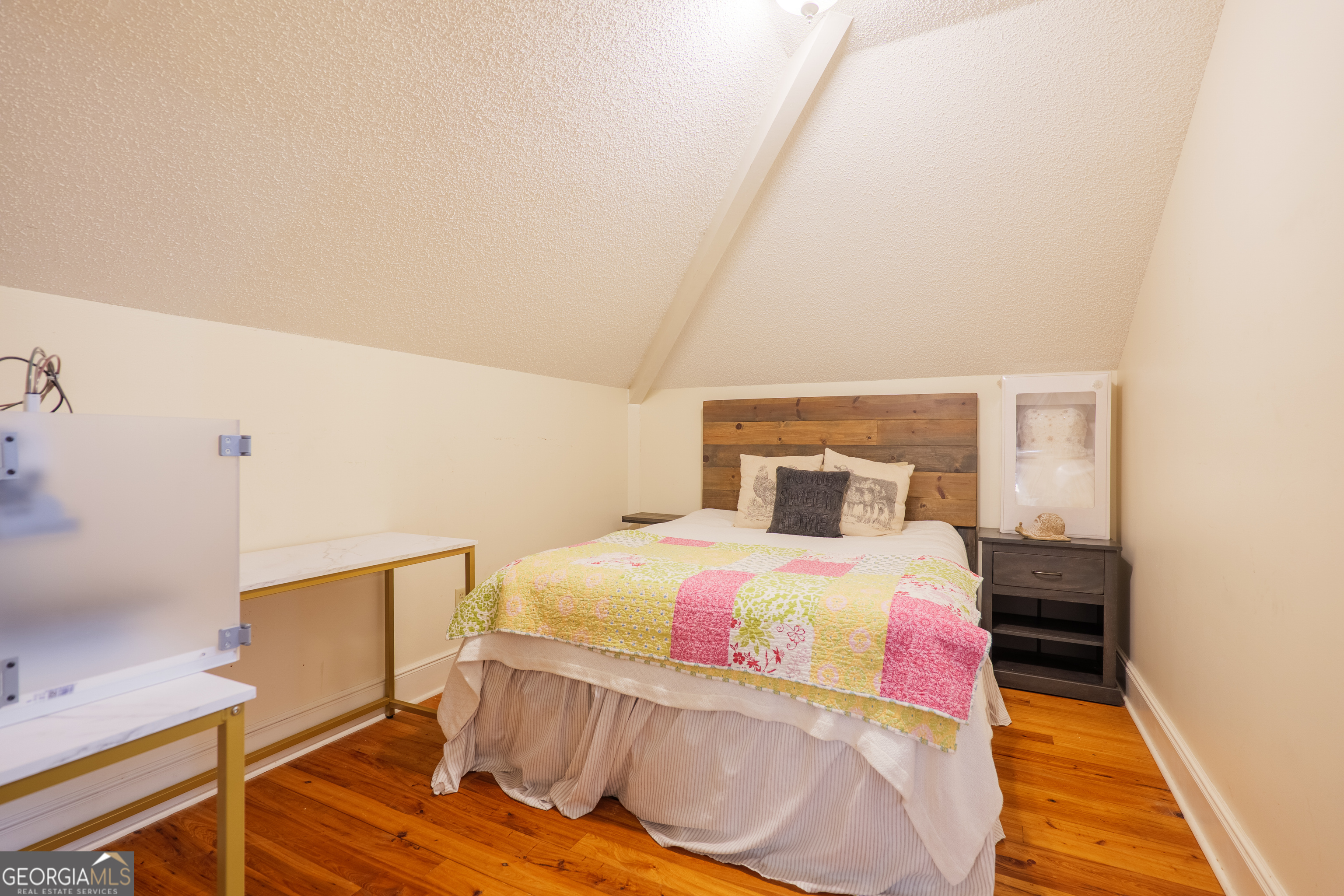 7552 Webb Road Hahira, GA 31632 - Photo 38 of 57 a bedroom with a bed and wooden floor