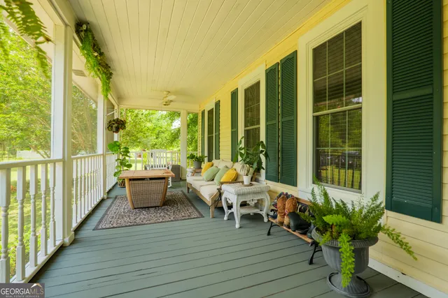 a balcony with chairs and wooden floor