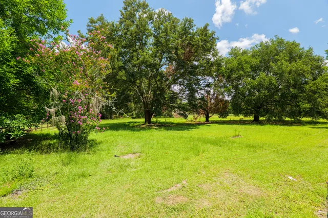 a view of a chair and tables in patio of house