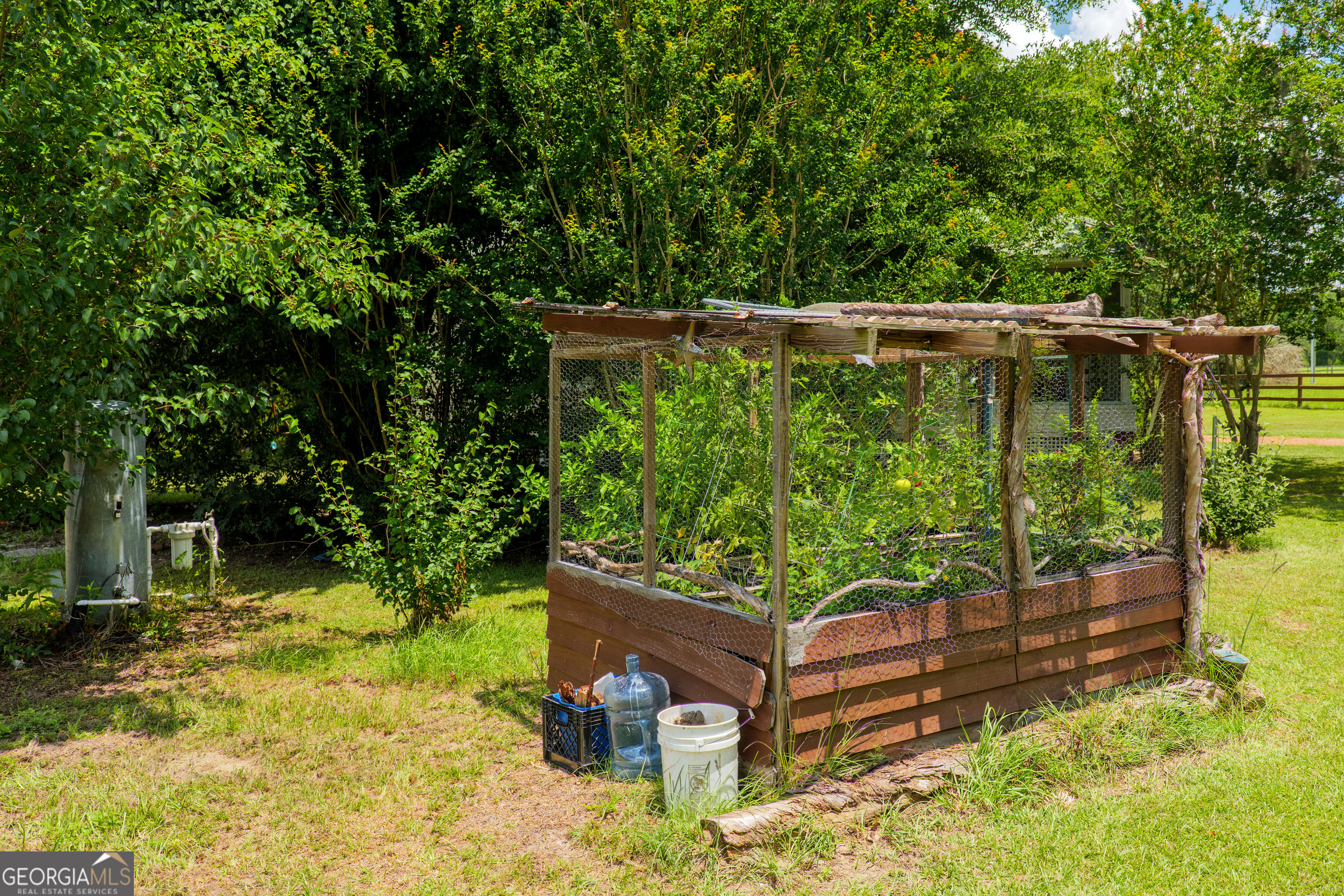 7552 Webb Road Hahira, GA 31632 - Photo 53 of 57 a wooden bench sitting in the backyard of a house
