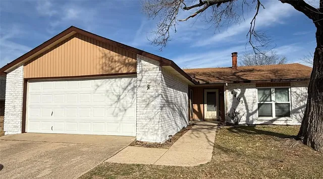 a view of a house with a wooden fence