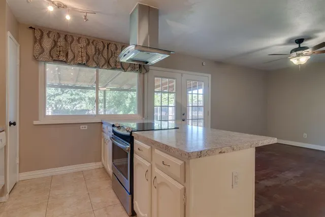 a kitchen with stainless steel appliances granite countertop a sink a stove and a refrigerator
