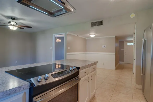 a kitchen with a stove and a refrigerator
