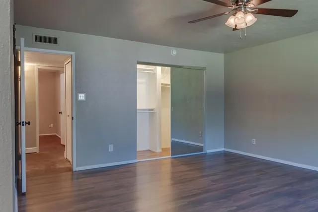 an empty room with wooden floor and door
