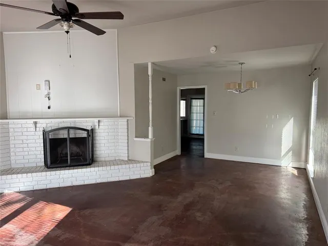 a view of a livingroom with a fireplace and cabinet