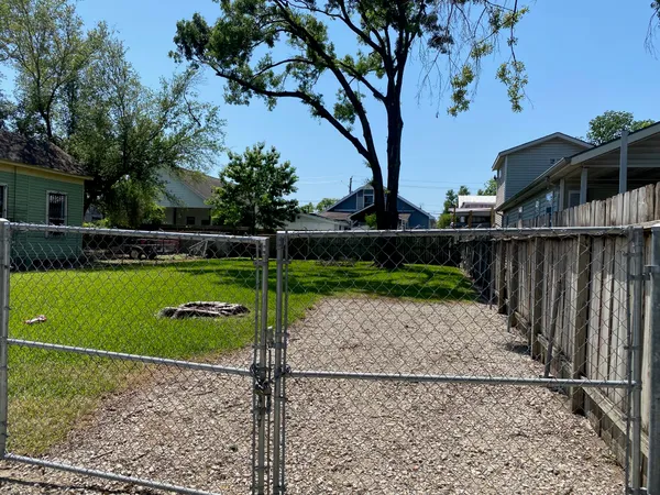 a view of a park with iron fence