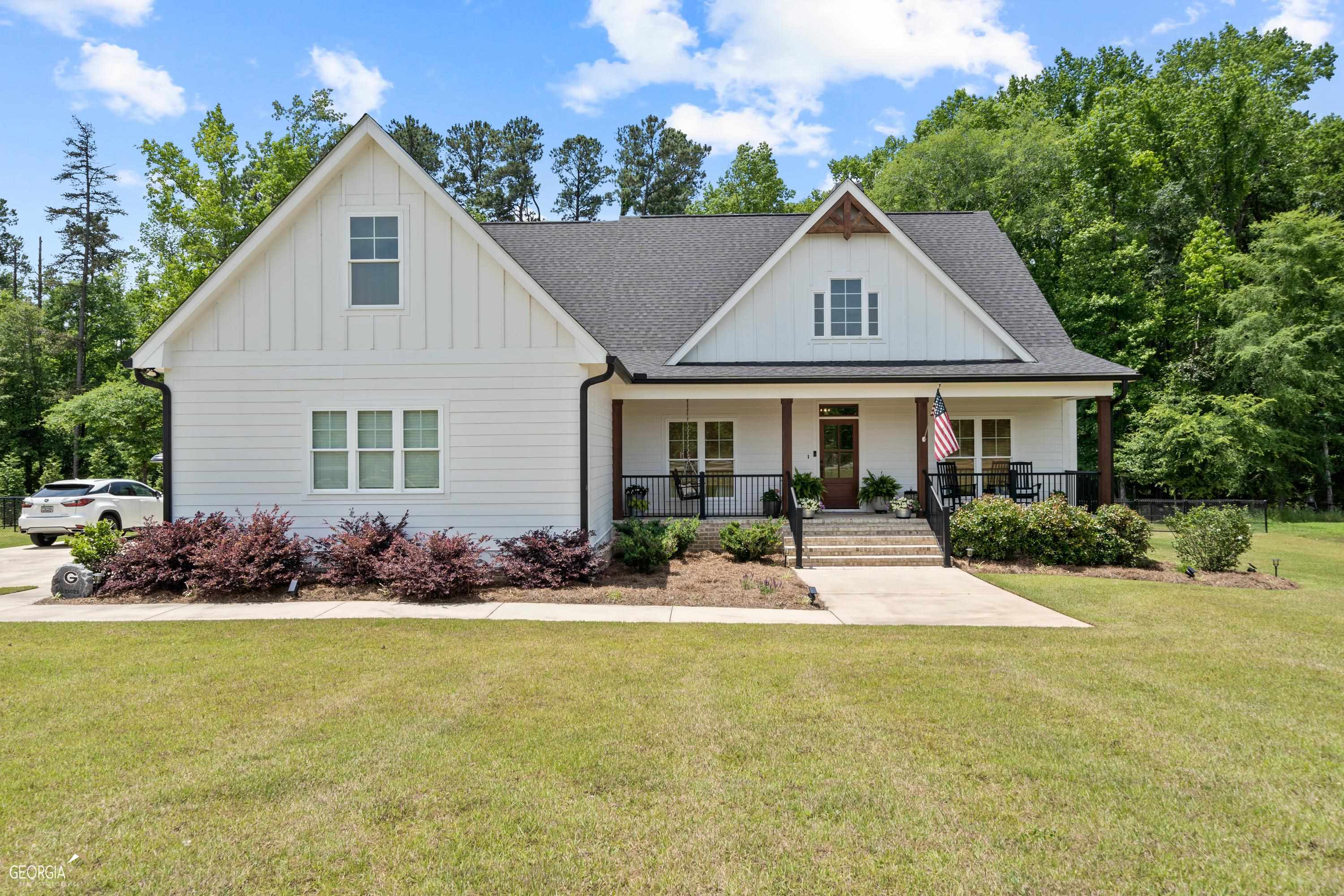 a front view of house with yard outdoor seating and green space