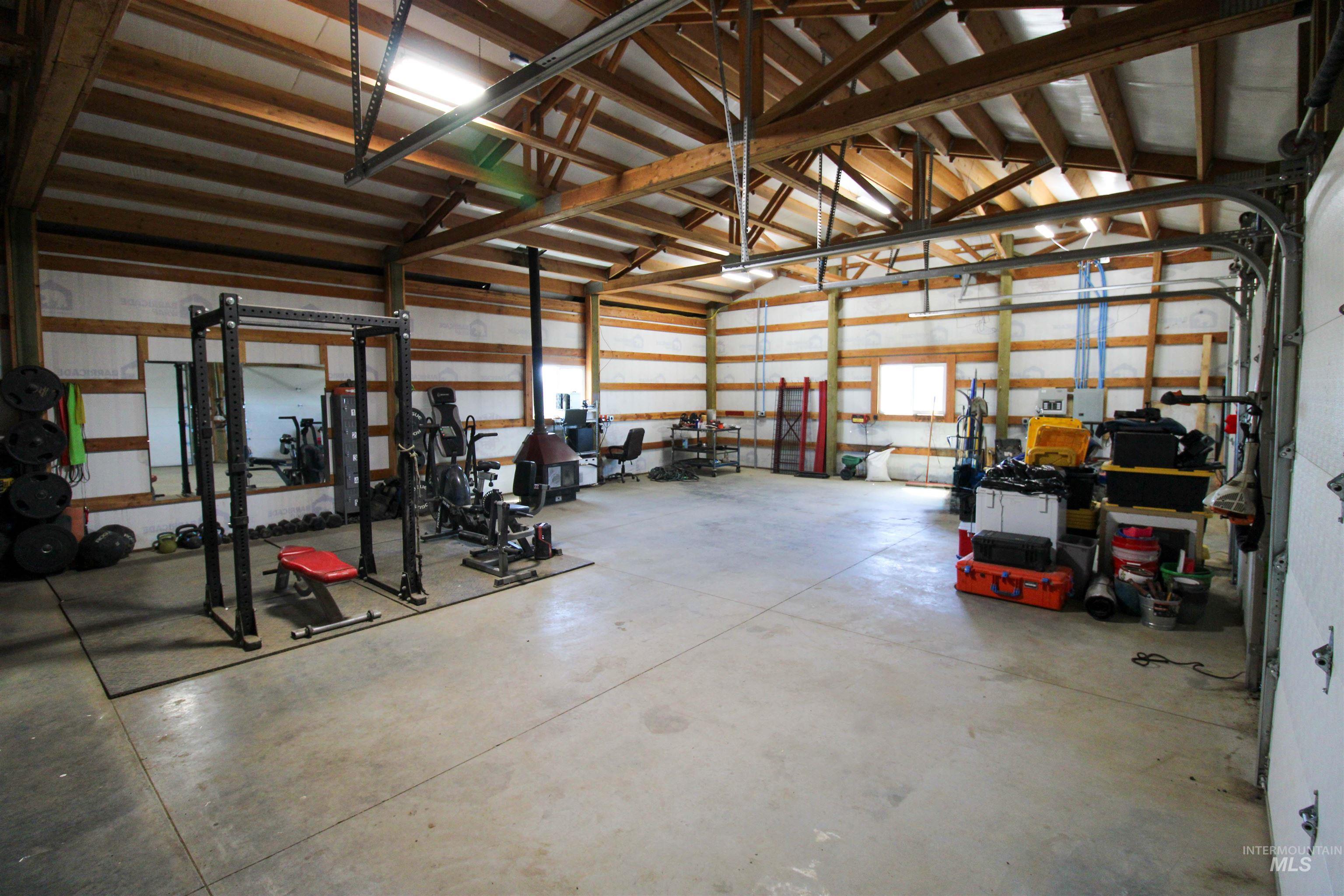 1254 Stuart Road Orofino, ID 83544 - Photo 16 of 48 Spacious utility building with concrete flooring, exposed wood beam ceiling, and multiple windows for natural light