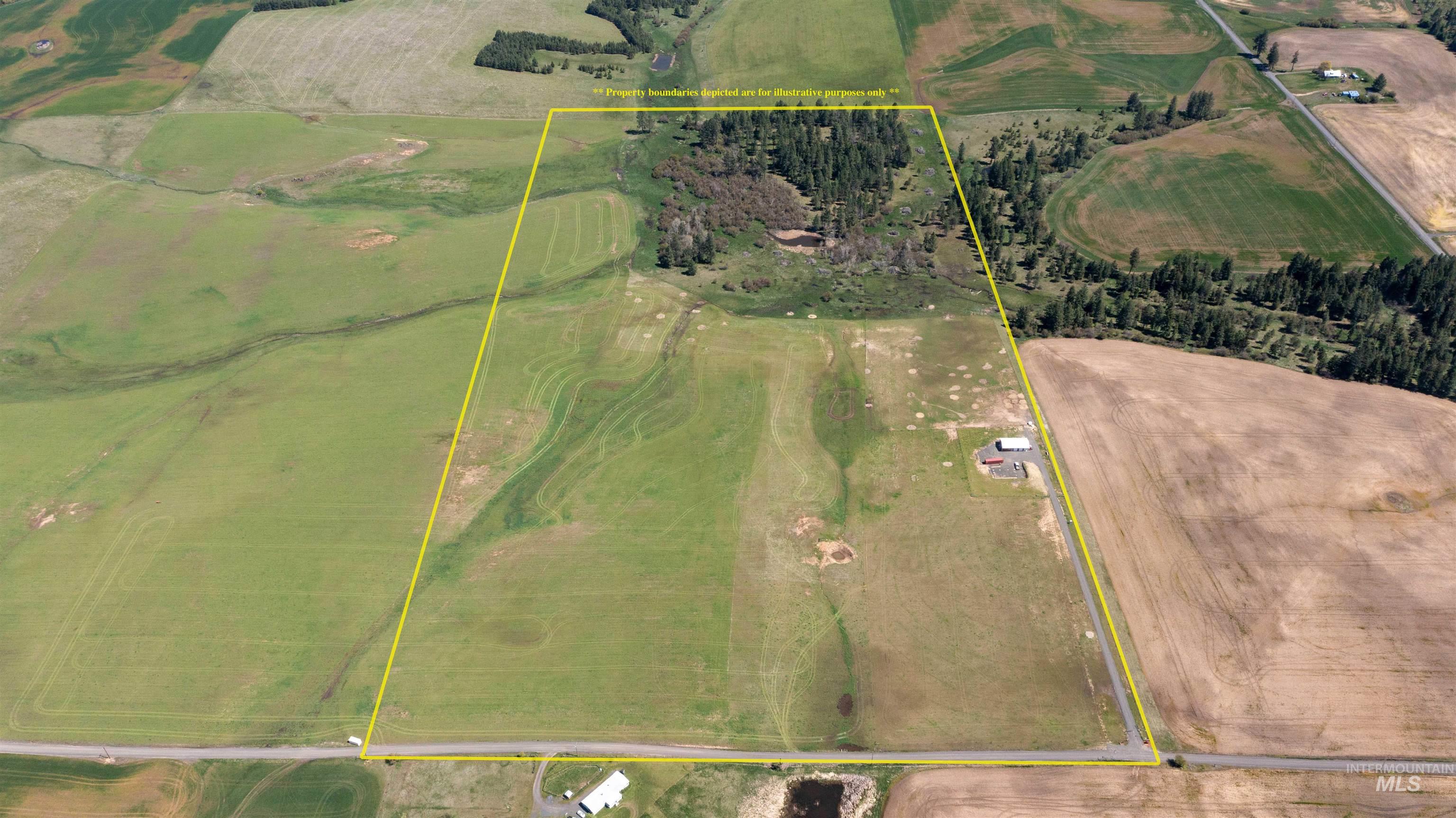 1254 Stuart Road Orofino, ID 83544 - Photo 48 of 48 Expansive rural acreage featuring a mix of open fields and forested areas, with a single-story structure