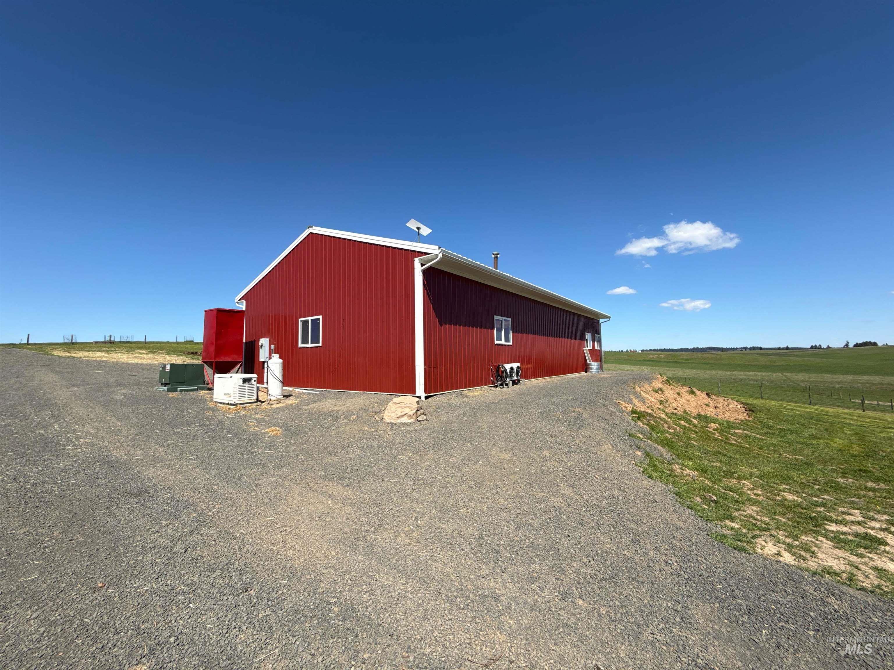 1254 Stuart Road Orofino, ID 83544 - Photo 6 of 48 Red corrugated metal exterior with white trim and multiple windows