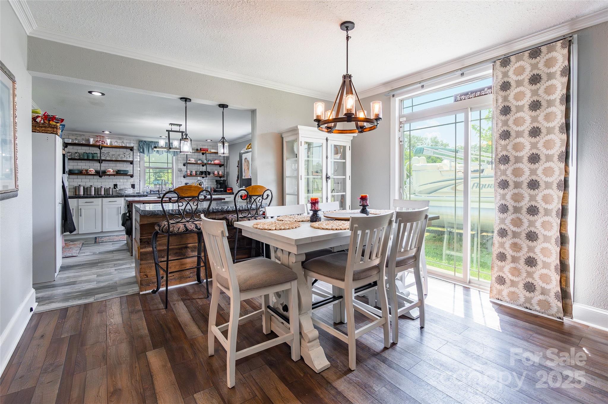 106 Guffey Road Cherryville, NC 28021 - Photo 8 of 41 a view of a dining room and livingroom with furniture wooden floor a chandelier