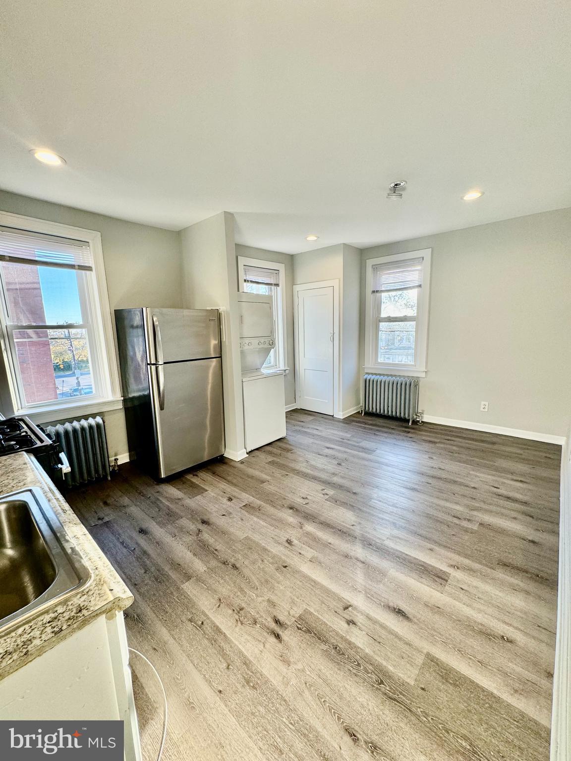 5388 Hazelhurst Street, Unit 3F Philadelphia, PA 19131 - Photo 2 of 6 a view of an empty room with window and wooden floor