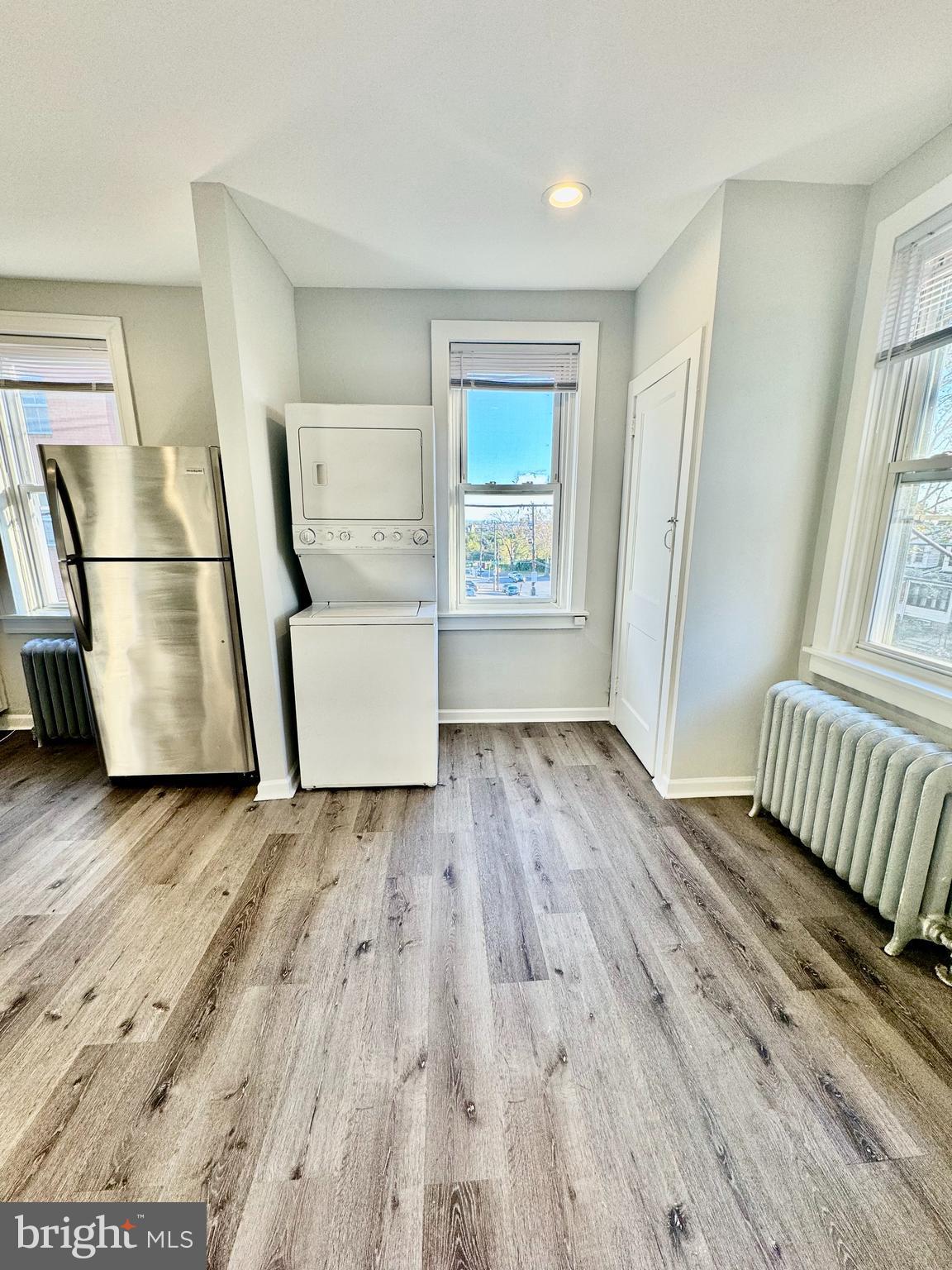 5388 Hazelhurst Street, Unit 3F Philadelphia, PA 19131 - Photo 3 of 6 wooden floor in an empty room with a window