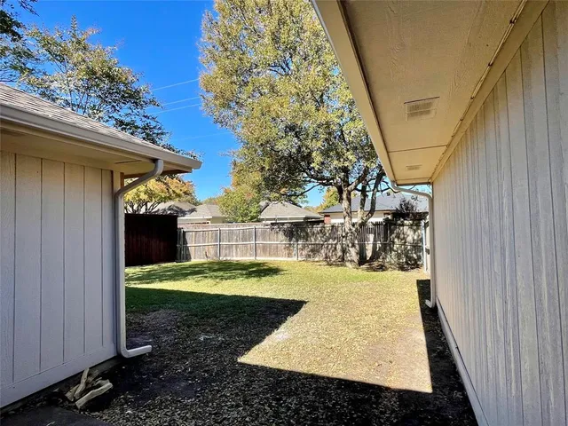 a view of a backyard with small cabin