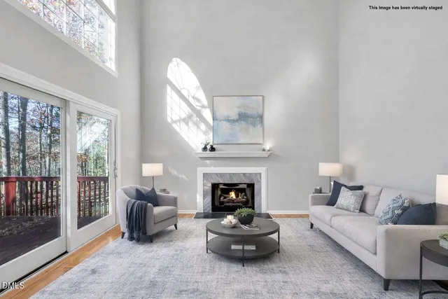 a view of empty room with wooden floor and fireplace