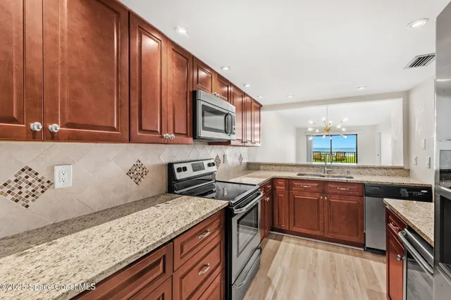a kitchen with a sink and a refrigerator