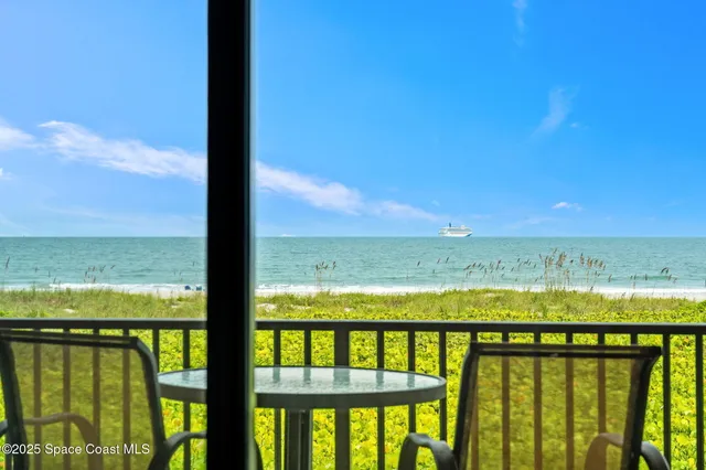 a view of a chairs and table in the balcony