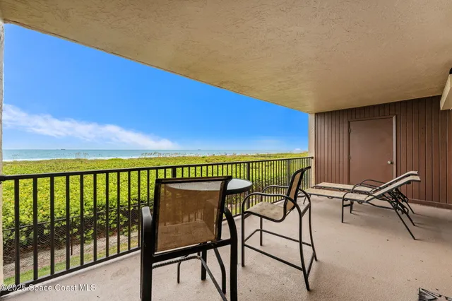 a view of a balcony with chairs