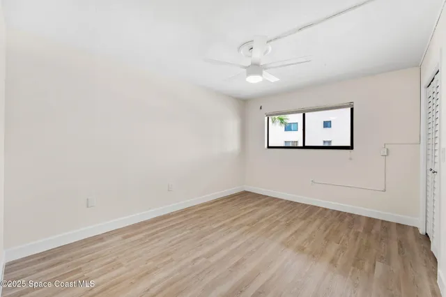 a view of a house with a yard and potted plants