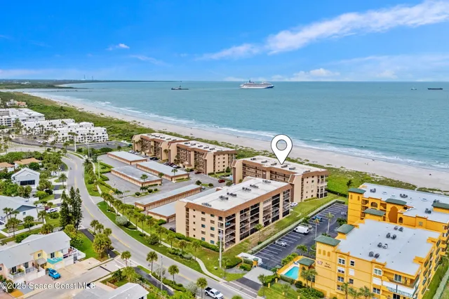 an aerial view of residential building and ocean