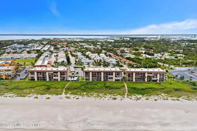 a view of a house with a small yard and plants