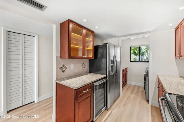 a bathroom with a sink a granite top and a shower