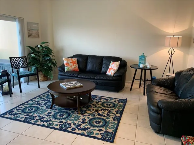 a living room with furniture and a rug