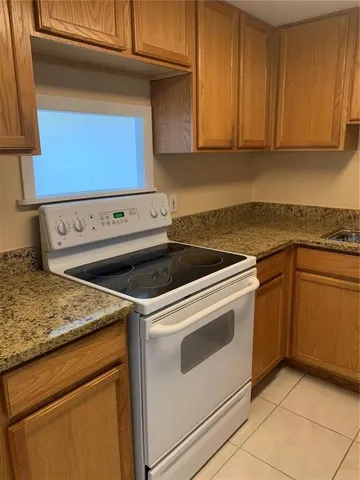 a bathroom with a granite countertop toilet and sink