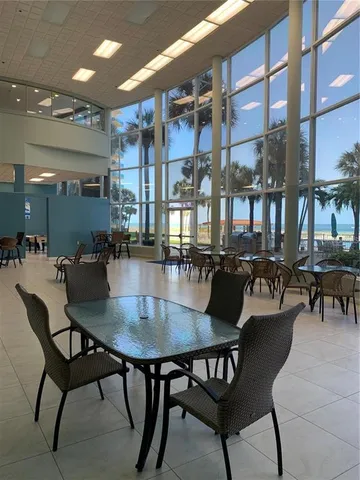 a room with furniture pool table and windows