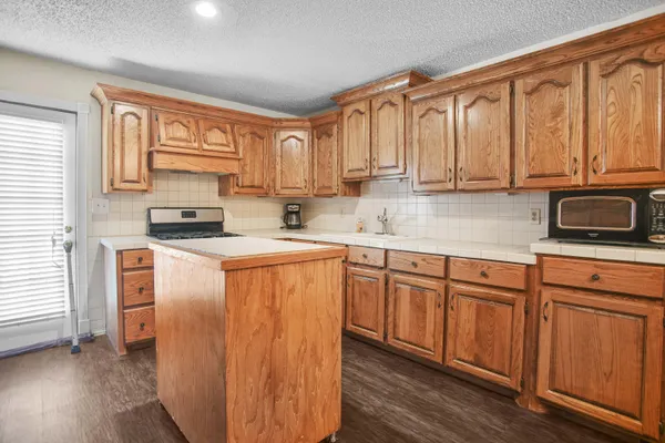 a kitchen with stainless steel appliances granite countertop a refrigerator sink and cabinets