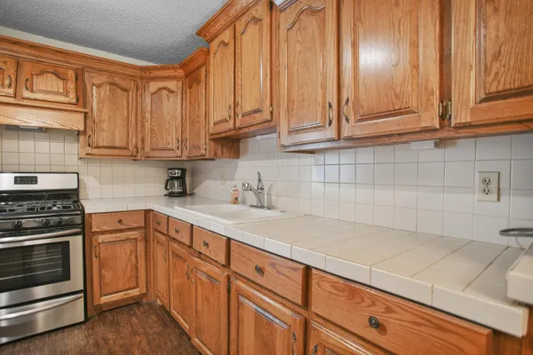 a kitchen with granite countertop cabinets stainless steel appliances and sink