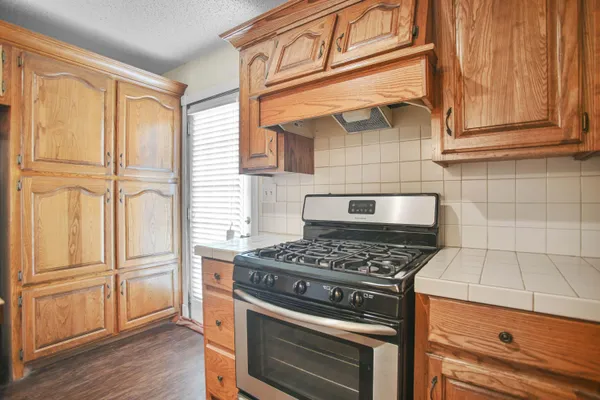 a kitchen with granite countertop cabinets and steel stainless steel appliances