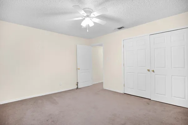 a view of a livingroom with a chandelier fan
