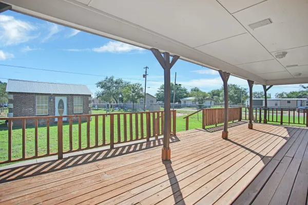 a view of balcony with wooden floor and fence