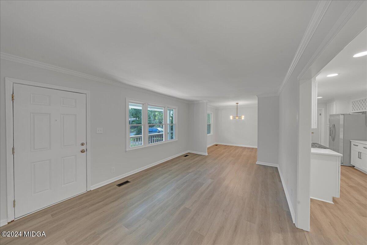 528 Table Mountain Drive Macon, GA 31220 - Photo 5 of 34 a view of an empty room with wooden floor and a window