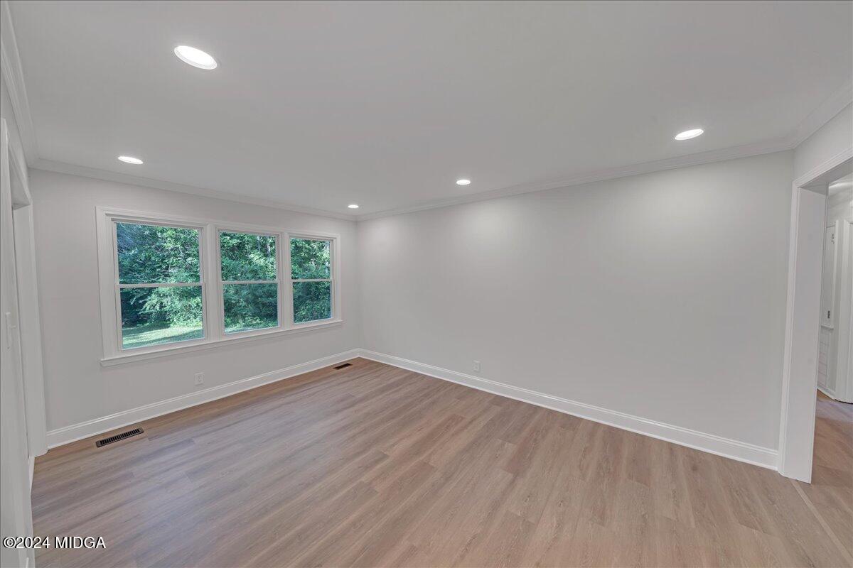 528 Table Mountain Drive Macon, GA 31220 - Photo 9 of 34 an empty room with wooden floor and windows