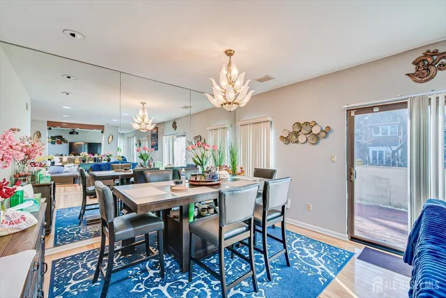 a view of a dining room with furniture wooden floor and chandelier