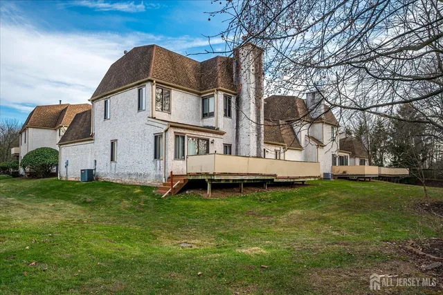 an aerial view of a house with swimming pool and garden