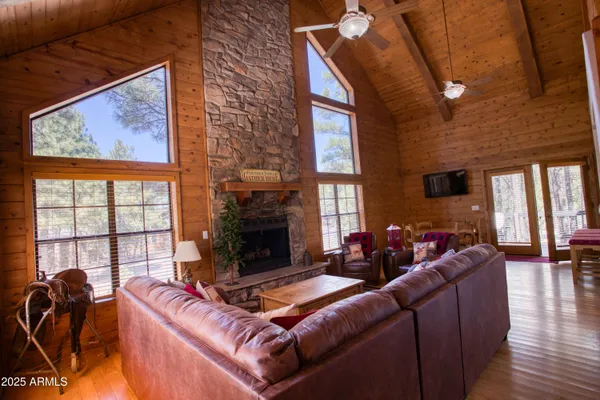 a living room with furniture a fireplace and windows