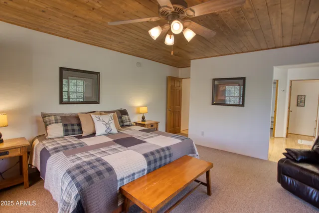 a bed room with a bed and a chandelier