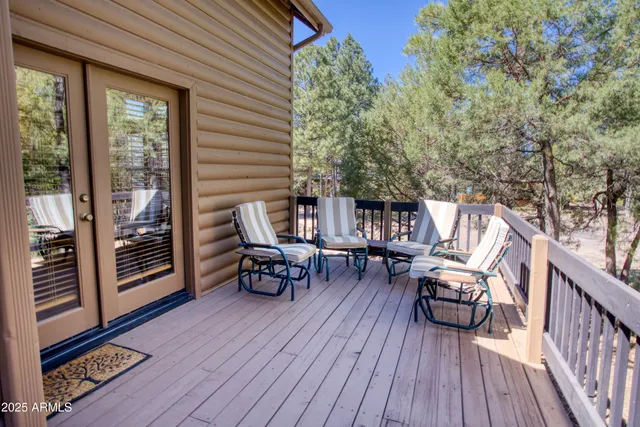 a view of a chairs and table on the wooden deck
