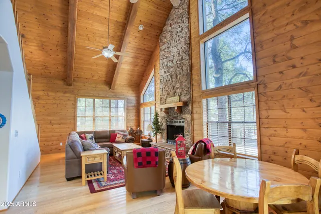 a living room with fireplace furniture and a large window
