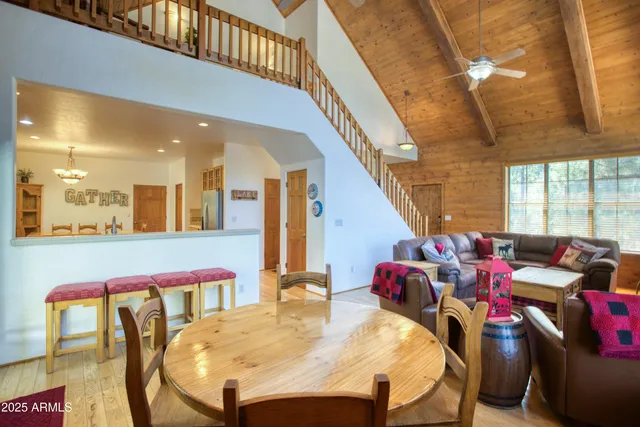 a dining room with furniture and a floor to ceiling window