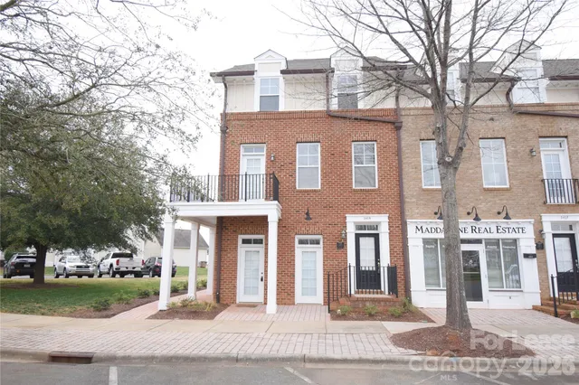 a front view of a building with garden