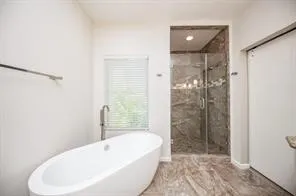 a bathroom with a bathtub and shower